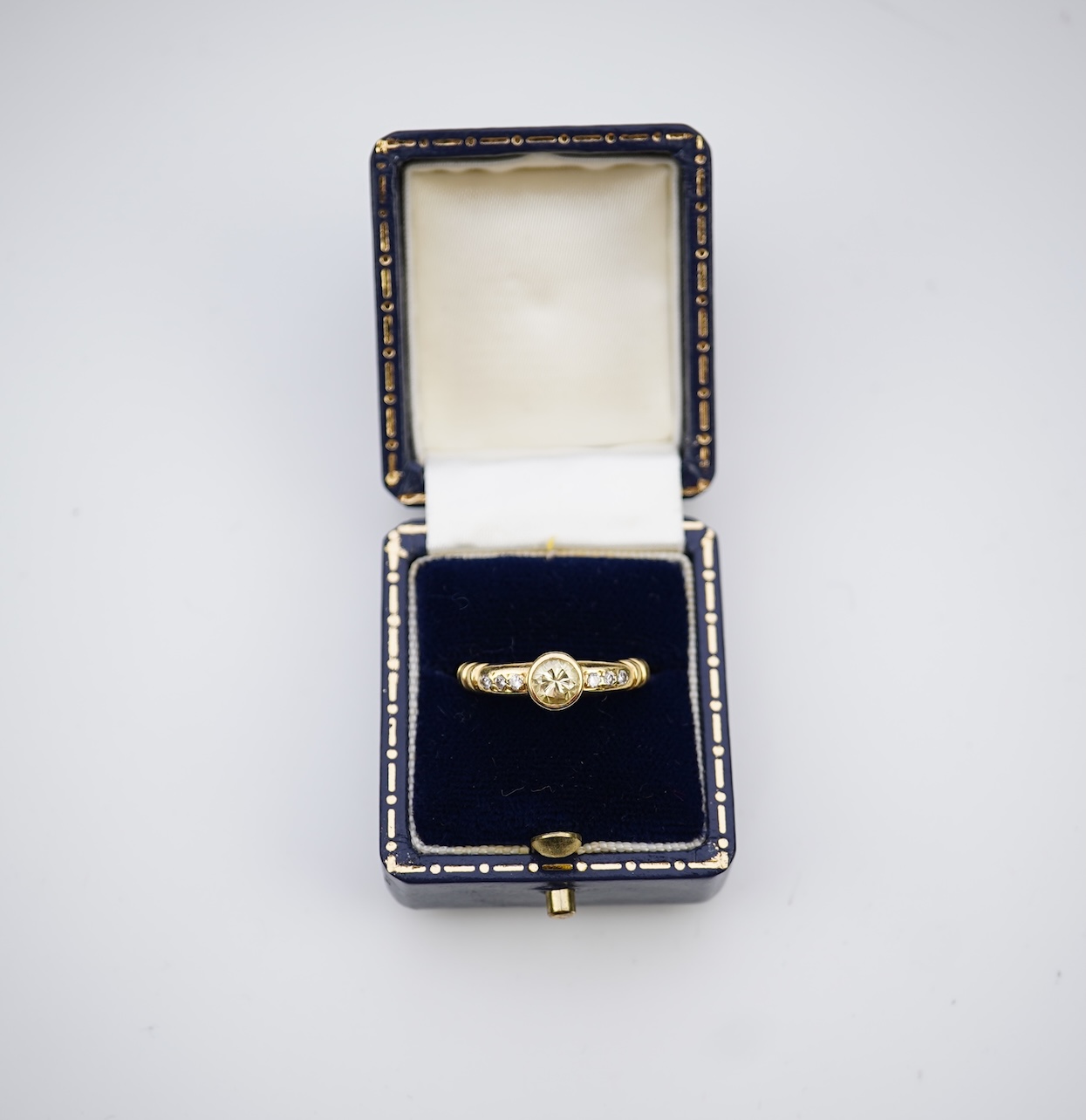 A yellow diamond and diamond ring